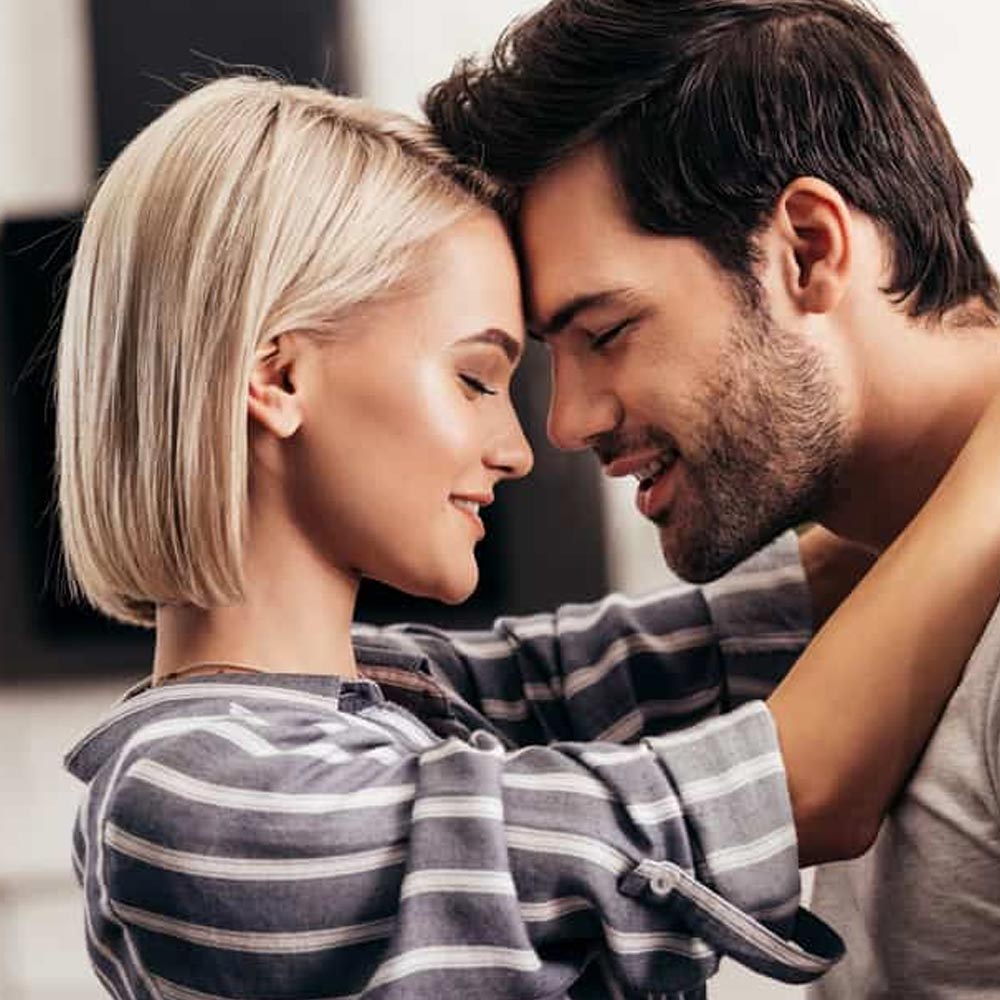 Man and woman touching foreheads