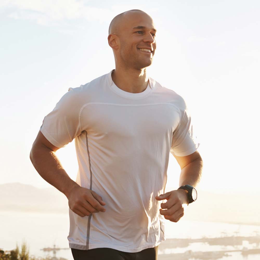 Man running along the coast